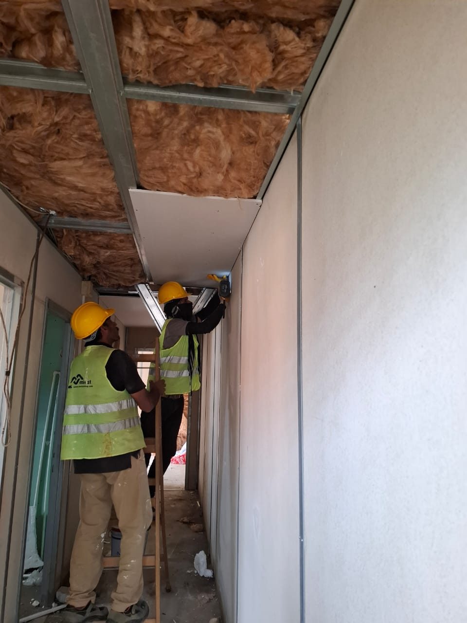 Ceiling boards and insulation going in
