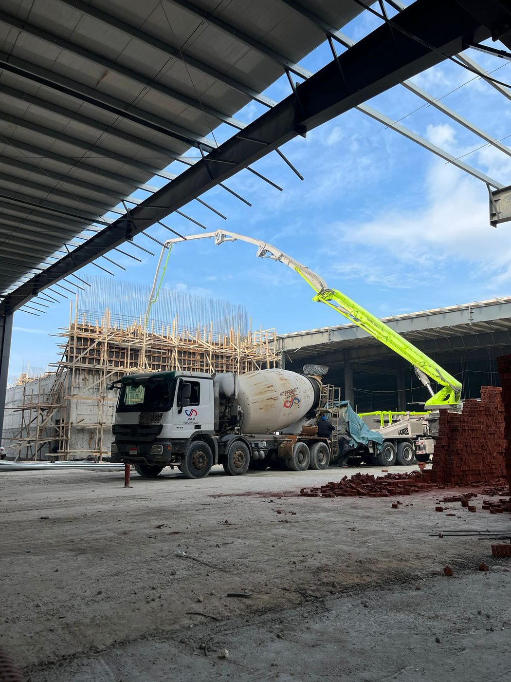 Boom pump concrete pour under the steel roof