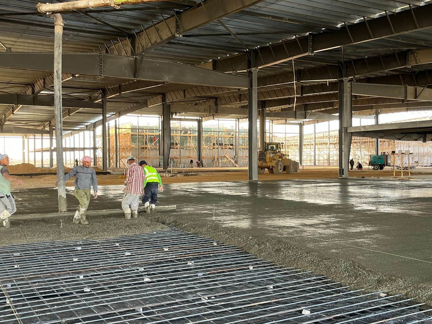 Concrete finishing crew in the industrial hall