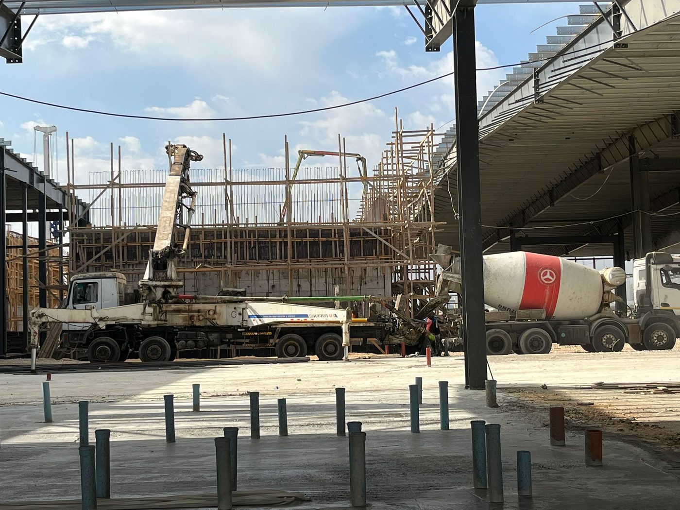 Pump and mixer trucks at the steel-frame hall