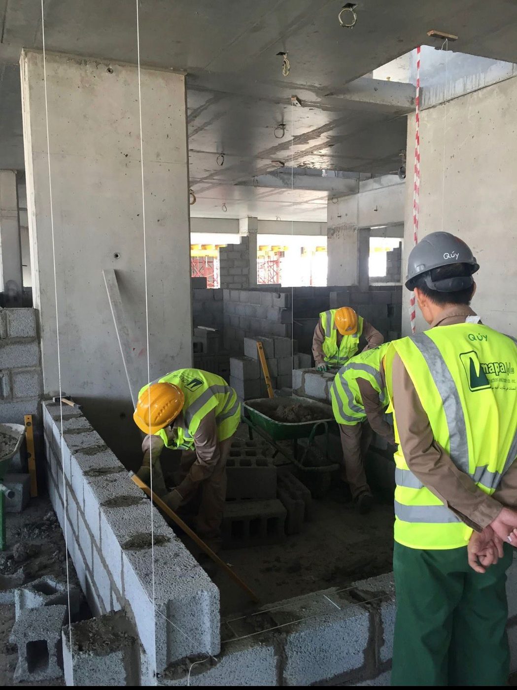 Masonry crew on concrete blockwork