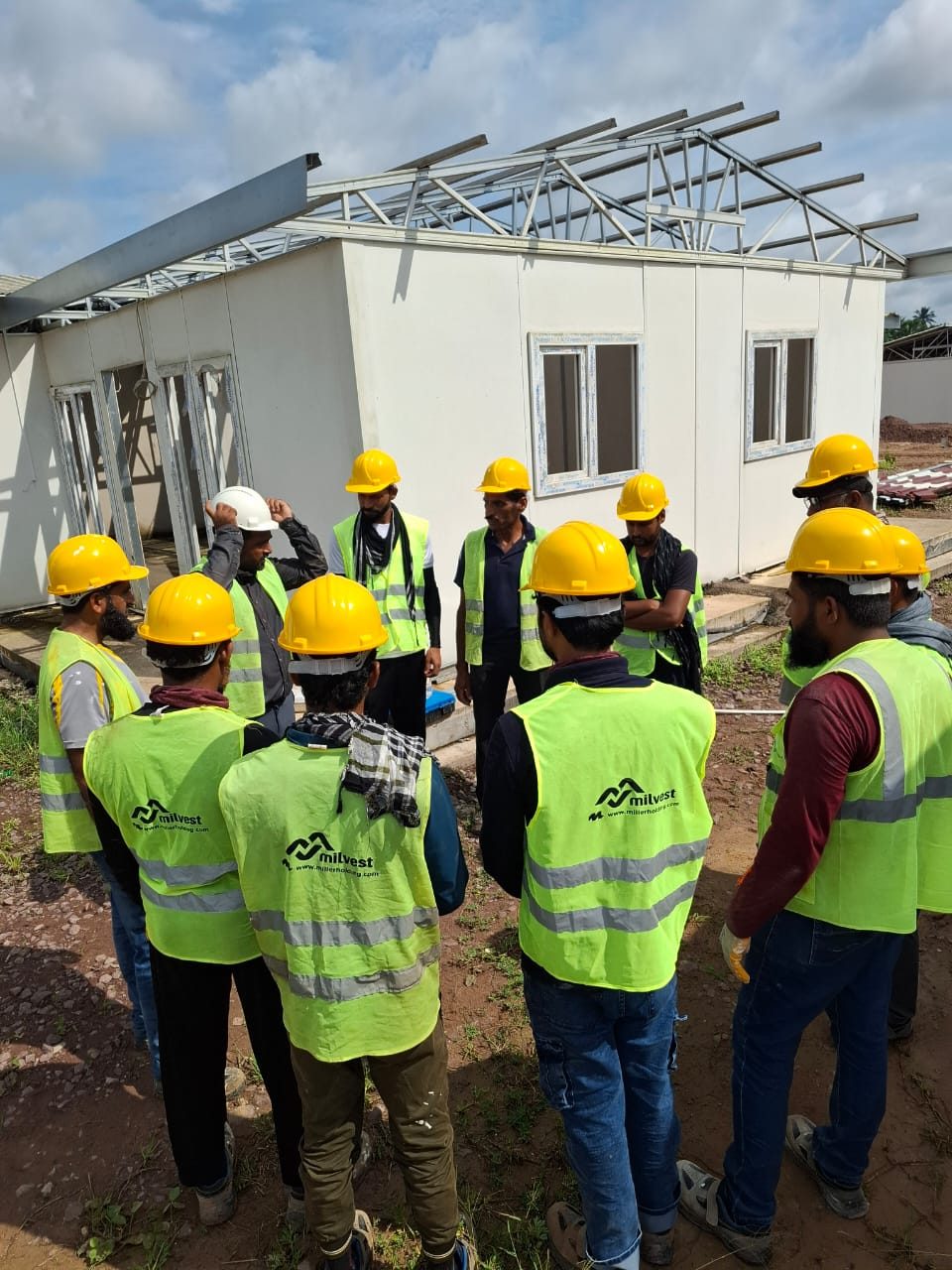 Morning toolbox talk at the prefab camp site