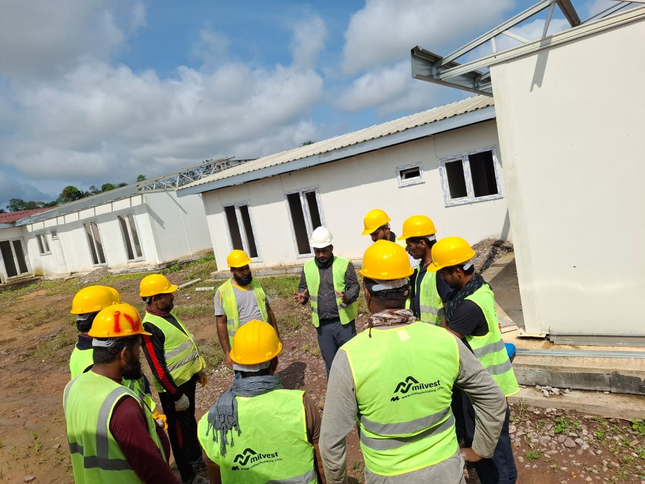 Supervisor briefing between modular camp blocks