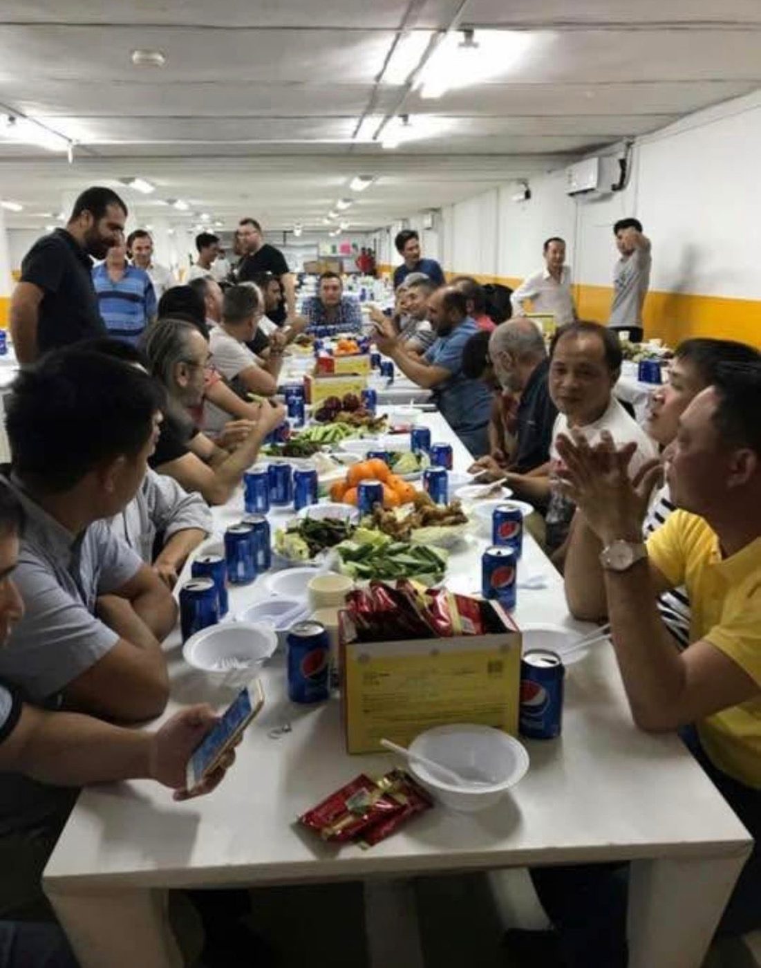Turkish and Vietnamese teams sharing a meal at camp