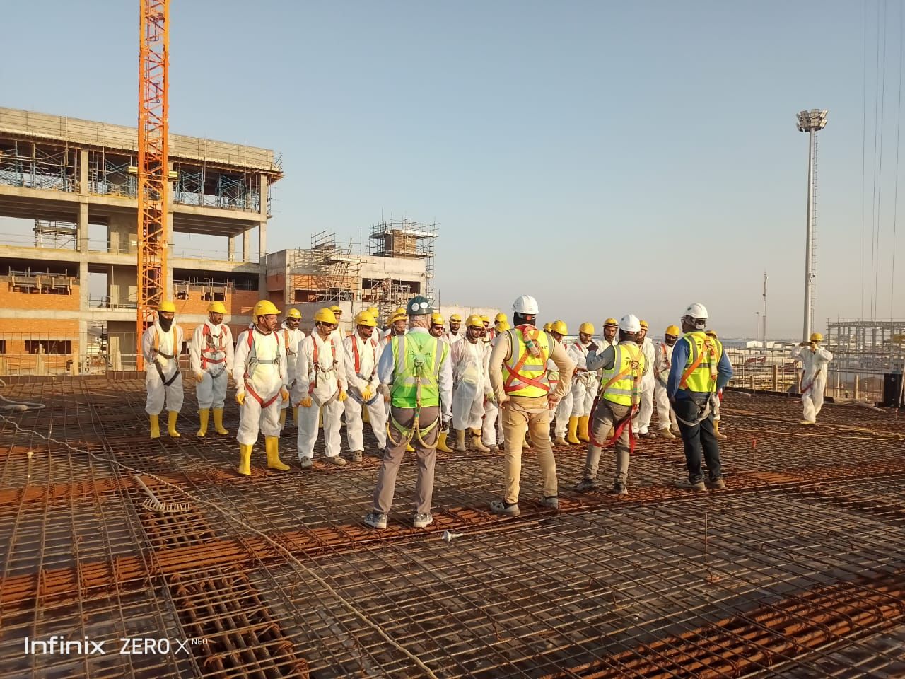 Construction workers fixing rebar on a Gulf project deck