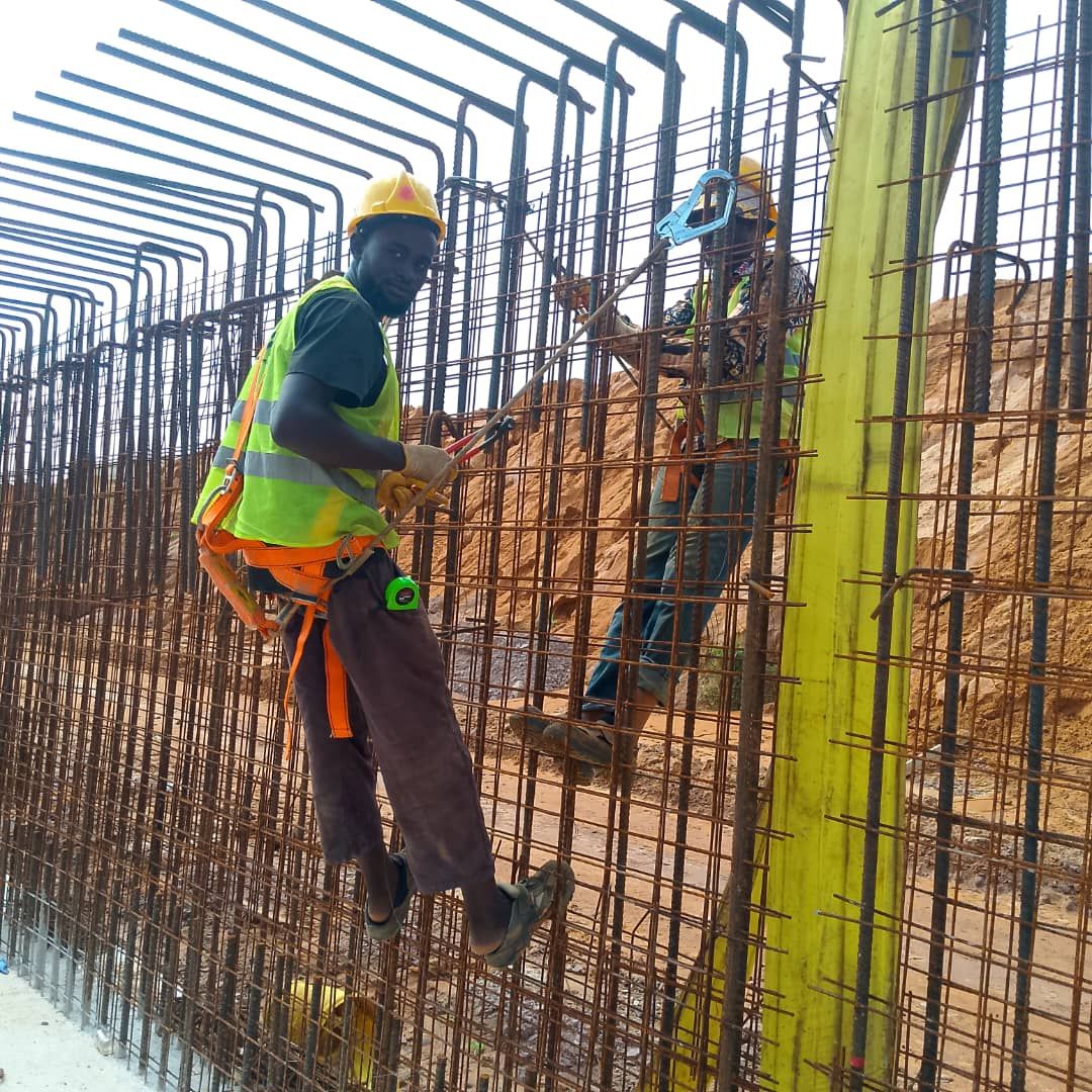 Steel fixer tying rebar on a column cage